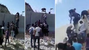 سوريون يتسلقون الجدار الاسمنتي و يتحدون الأسلاك الشائكة للوصول إلى تركيا ( فيديو )